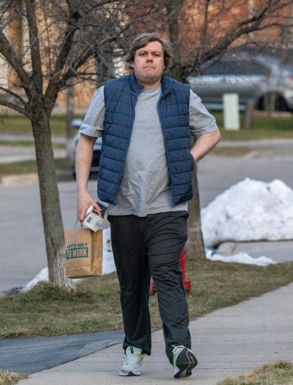 Kayla Lemieux, not wearing her large breast, walks towards their car in Toronto, Burlington, Ontario, on Feb, 13, 2023.