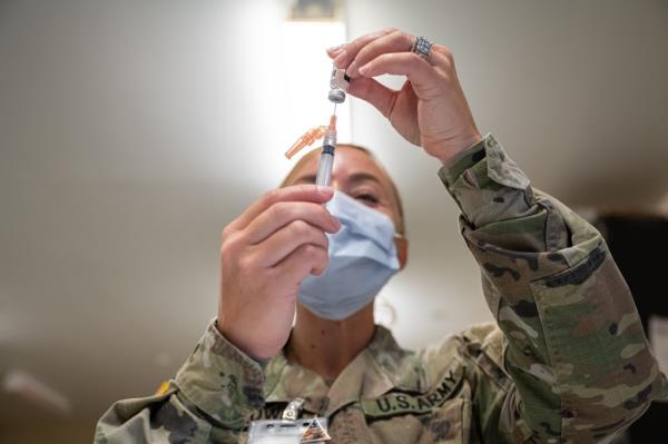 A Preventative Medicine Services technician fills a syringe with a Janssen COVID-19 vaccine on September 9, 2021 in Fort Knox, Kentucky. 