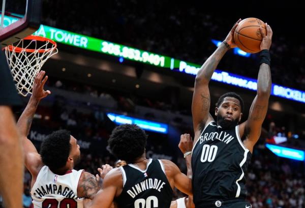 Royce O'Neale grabs a rebound during the Nets' 107-104 preseason win over the Heat.
