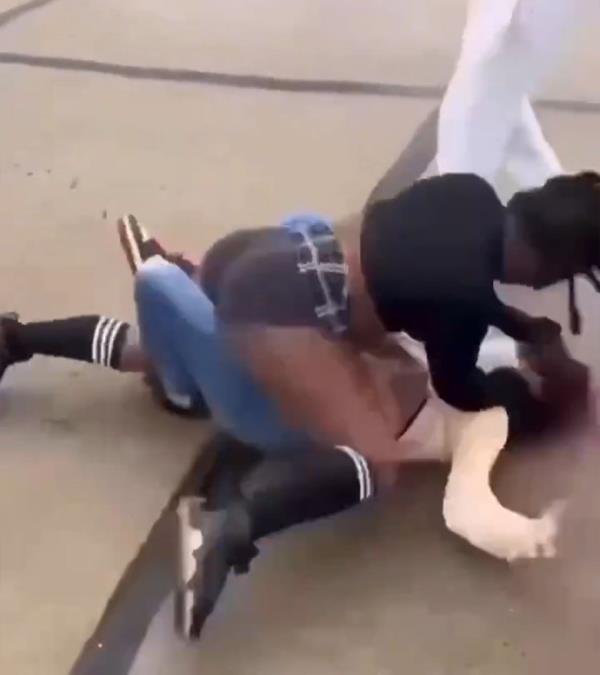 The attacker is seen grabbing the victim's head.