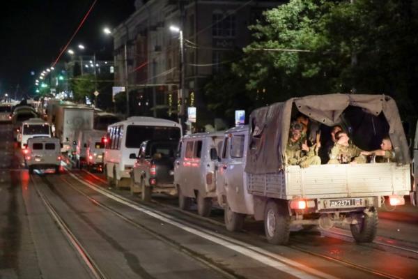 Members of the Wagner Group military company sit in their military vehicles 