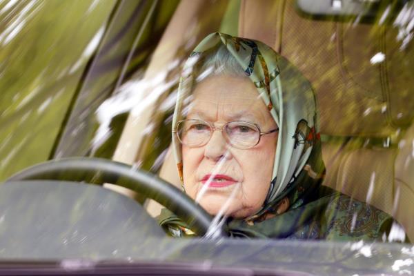 A photo of Queen Elizabeth II behind the wheel of a Range Rover, one of her many vehicles.