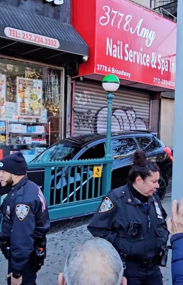 Car lodged in a Washington Heights subway station entrance.