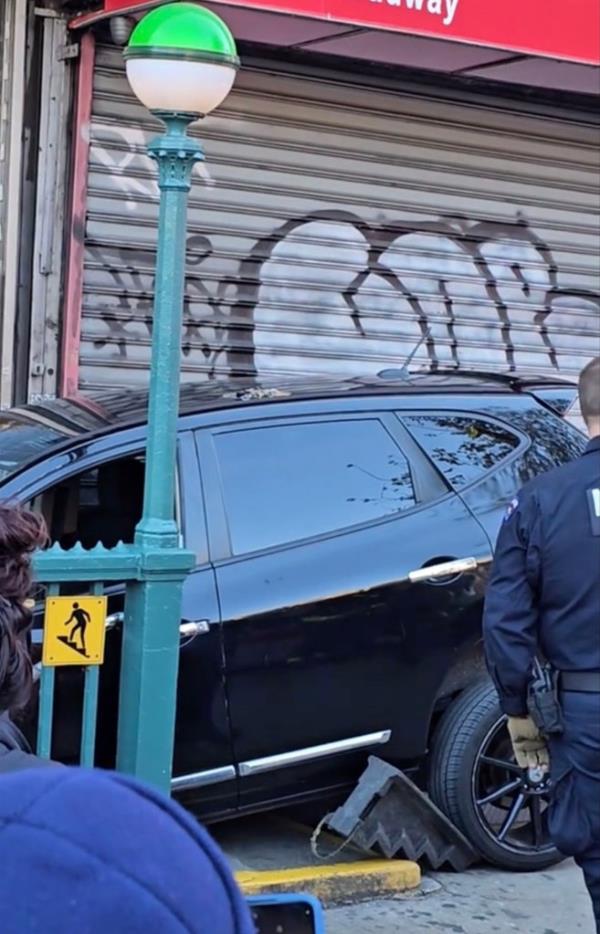 The SUV was stuck at the 157th Street entrance of the 1 train.