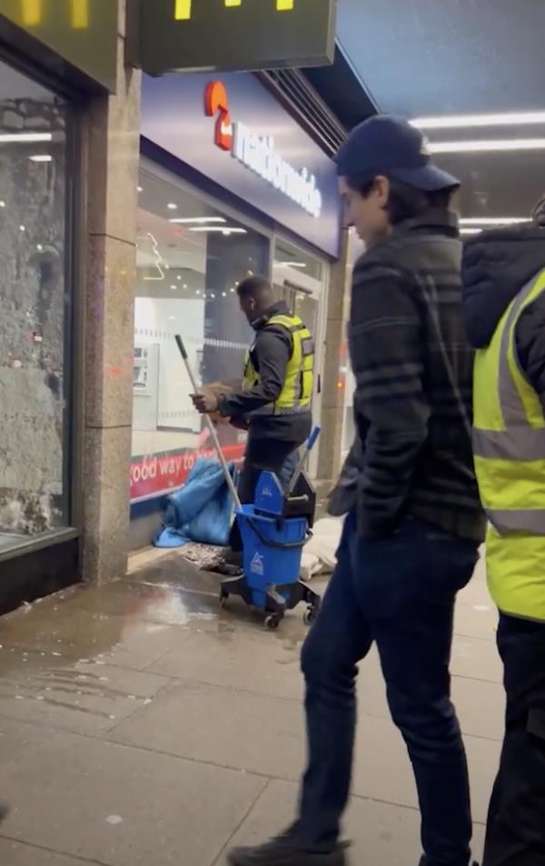 The guard mopping the floor