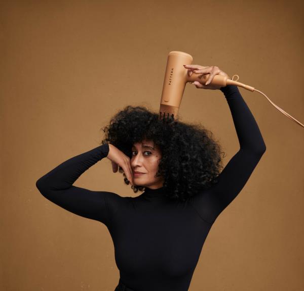Image of Tracee Ellis Ross posing with a blowdryer