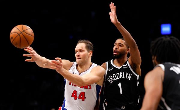 Detroit Pistons forward Bojan Bogdanovic (44) passes the ball away from Brooklyn Nets forward Mikal Bridges (1) during the second half of an NBA basketball game