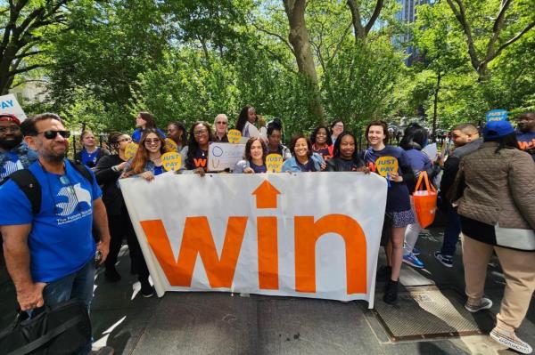 WIN logo on sign at an outdoor event