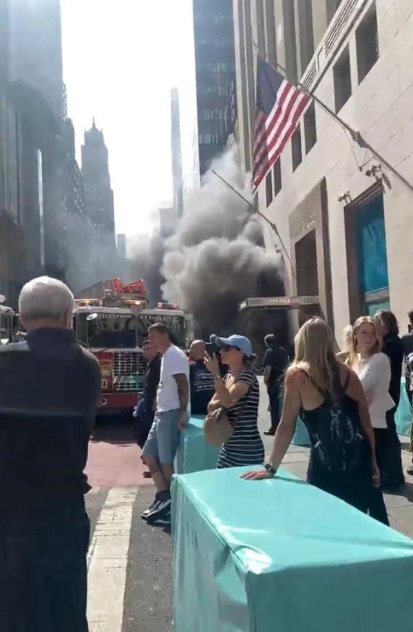 People standing outside of the ico<em></em>nic Manhattan store during the fire.