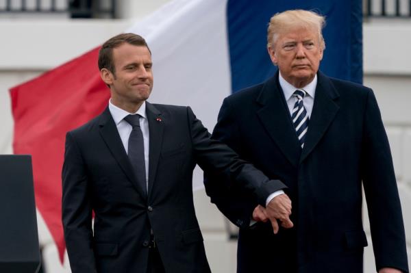 Trump and French President Emmanuel Macron hold hands during a ceremony at the White House on April 24, 2018.