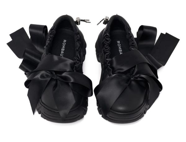 A pair of trendy black ballet sneakers with bows