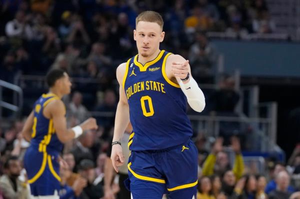 Golden State Warriors guard Do<em></em>nte DiVincenzo (0) gestures after shooting a 3-point basket against the Dallas Mavericks during the first half of an NBA basketball game in San Francisco, Saturday, Feb. 4, 2023.