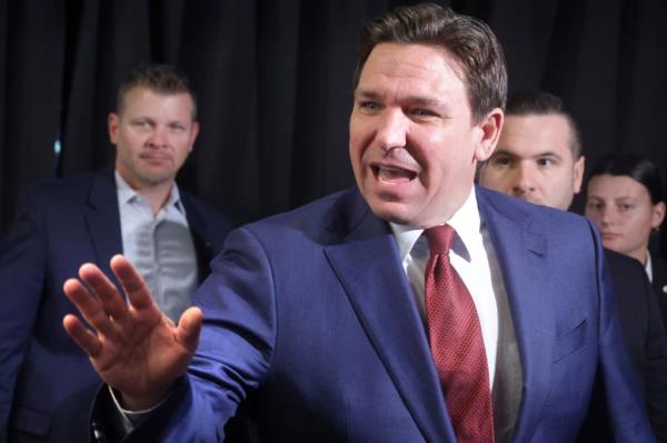 Florida Governor Ron DeSantis waving goodbye after delivering remarks at a press co<em></em>nference at Walt Disney World, discussing the success of a co<em></em>ntroversial law.