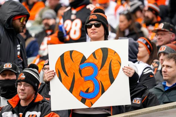 A fan holds a poster ho<em></em>noring injured Buffalo Bills player Damar Hamlin before an NFL football game between the Baltimore Ravens and the Cincinnati Bengals in Cincinnati, Sunday, Jan. 8, 2023.