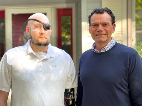 Aaron James of Hot Springs, Arkansas, poses with Dr. Eduardo D. Rodriguez after he underwent surgery for the world?s first whole-eye transplant as part of a partial face transplant at NYU Langone in an undated photograph. James survived a deadly 7200-volt electric shock while working as a high-voltage lineman in June 2021. NYU Langone Health/Handout via REUTERS NO RESALES. NO ARCHIVES. THIS IMAGE HAS BEEN SUPPLIED BY A THIRD PARTY