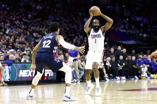James Harden #1 of the LA Clippers tries to pass past Tobias Harris #12 of the Philadelphia 76ers during the second quarter at the Wells Fargo Center on March 27, 2024 in Philadelphia, Pennsylvania.  
