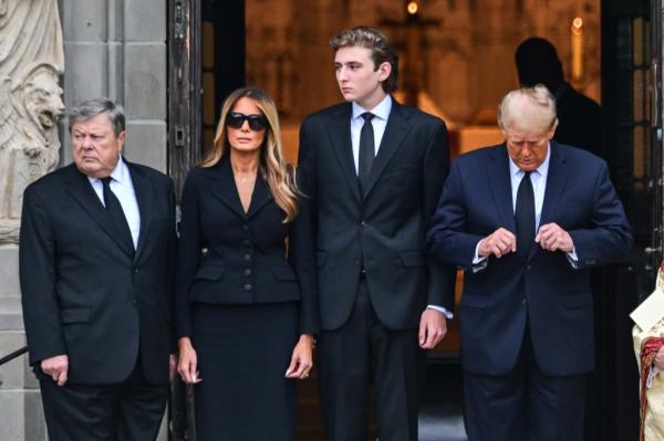 Do<em></em>nald Trump (R) stands with his wife Melania Trump (2L) their son Barron Trump (C) and father-in-law Viktor Knavs, at the start of a funeral for Amalija Knavs, the former first lady's mother