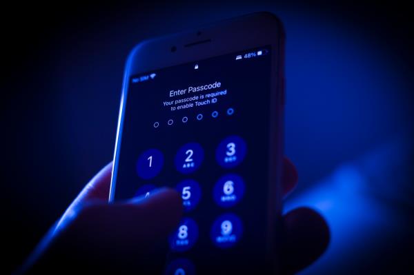 A mobile phone passcode security screen is seen in this photo illustration in Warsaw, Poland on 31 Poland, 2022. Digital rights groups are urging the federal government to rule out requiring identification docu<em></em>ments as part of a proposed o<em></em>nline age-verification system. Rights groups are warning it could create a ho<em></em>neypot of peoples perso<em></em>nal information and pornography-viewing habits. (Photo by STR/NurPhoto via Getty Images)