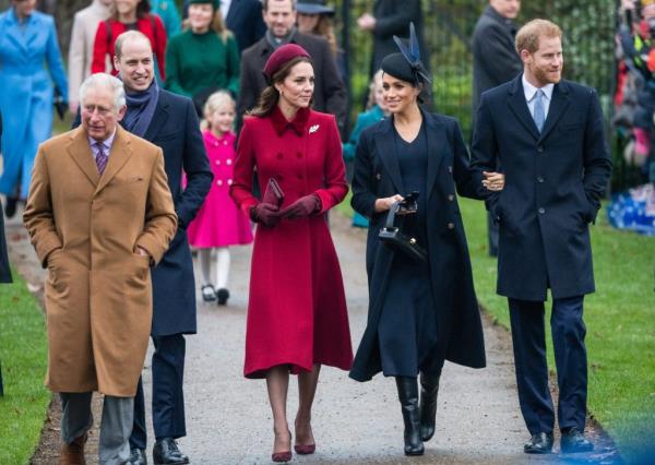 A group of people including Prince Charles, Prince William, Duke of Cambridge, Catherine, Duchess of Cambridge, Meghan, Duchess of Sussex and Prince Harry, Duke of Sussex are walking on a path outside Church of St Mary Magdalene on the Sandringham estate on 25 December 2018.