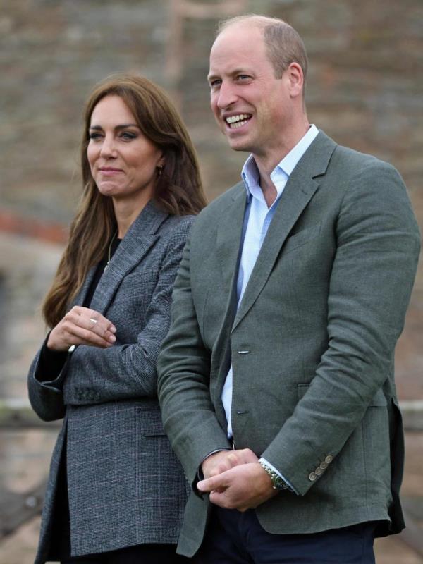 Prince William and Princess Catherine react while standing on a farm.