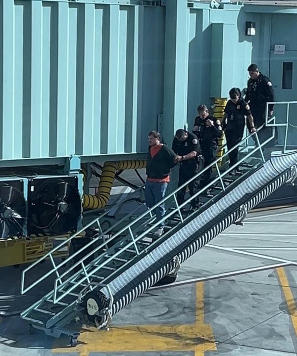 man tackled on plane