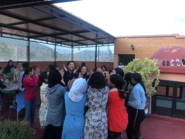 A photo showing a group of young girls dancing on the rooftop of a boarding house in Asni