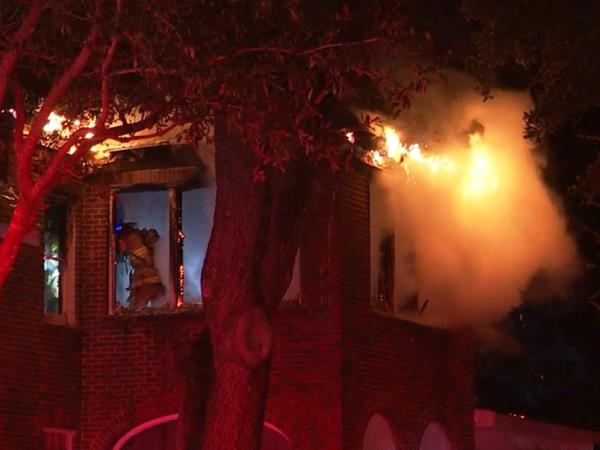 A firefighter is seen battling the blaze.
