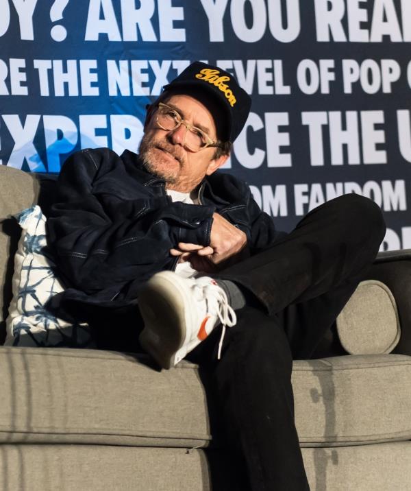 Michael J Fox sitting on a couch. 