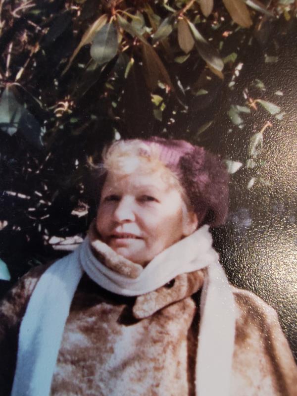 a younger Chodowiec in a coat with a white scarf on her neck