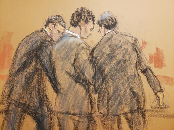 Bankman-Fried stands with his lawyers after the verdict is read on Nov. 2.