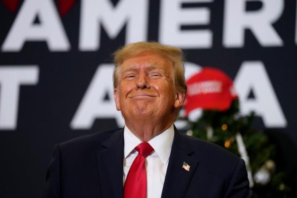 Former President Do<em></em>nald Trump reacts to supporters during a commit to caucus rally, Tuesday, Dec. 19, 2023, in Waterloo, Iowa. 