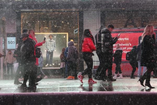 Snowfall is seen in New York City, as flakes were falling across the five boroughs Mo<em></em>nday night into Tuesday morning with a dusting covering sidewalks and cars.