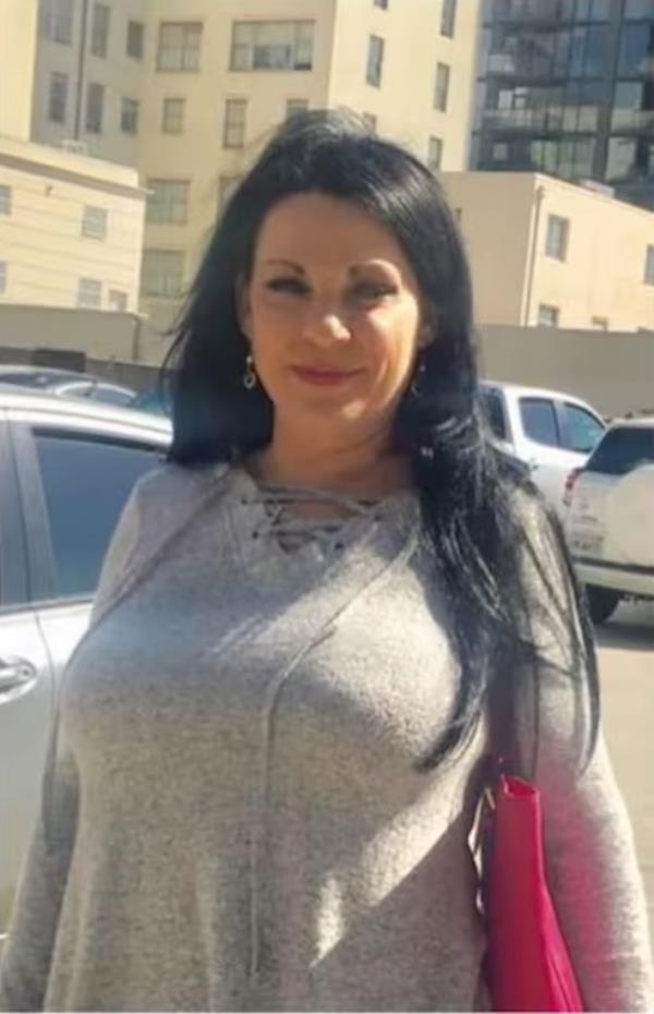 Marianne Smyth smiling at the camera, accused of scamming her victims out of more than $170,000