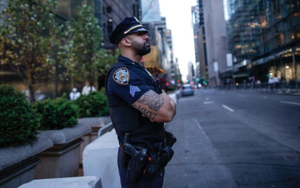 A police officer wears a beard while on duty in NYC.