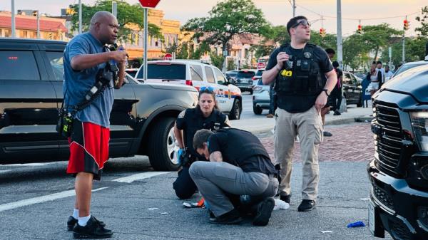police officers examining something on the ground