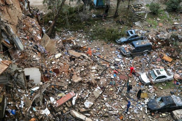 People inspect the damage at the site of an overnight Israeli airstrike that targeted the Chayah neighborhood in Beirut's southern suburbs on Nov. 26, 2024.