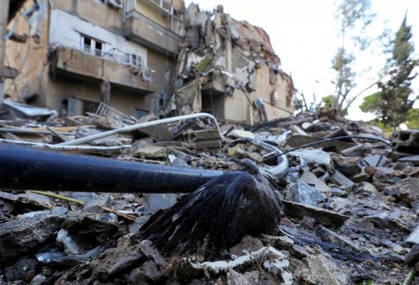 People inspect the damage at the site of an overnight Israeli airstrike that targeted the Chayah neighborhood in Beirut's southern suburbs on Nov. 26, 2024.