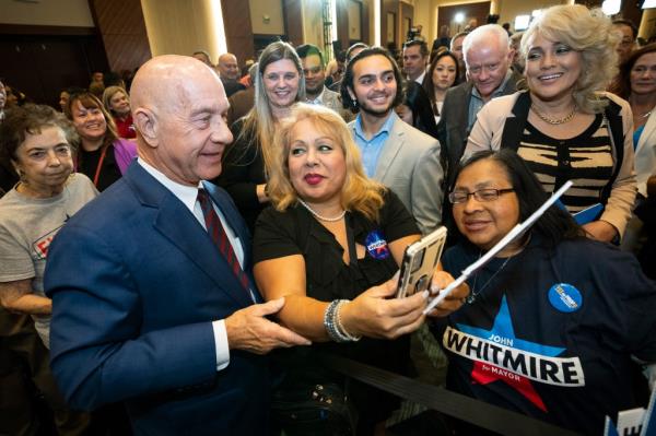 Whitmire takes photos with his supporters during an election watch party, Tuesday, Nov. 7, 2023, in Houston. 