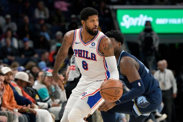 Philadelphia 76ers forward Paul George (8) handles the ball ahead of Memphis Grizzlies forward Jaren Jackson Jr. (13) in the first half of an NBA basketball game Wednesday, Nov. 20, 2024, in Memphis, Tenn.