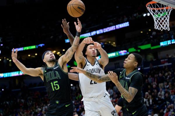 New Orleans Pelicans guard Jose Alvarado (15), Brooklyn Nets forward Jalen Wilson (22), and New Orleans Pelicans guard Jordan Hawkins (24) vie for a rebound during the second half at Smoothie King Center. 
