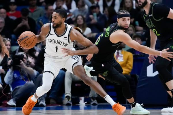 Brooklyn Nets forward Mikal Bridges (1) moves the ball past New Orleans Pelicans guard Jose Alvarado in the second half of an NBA basketball game in New Orleans, Tuesday, Jan. 2, 2024. 