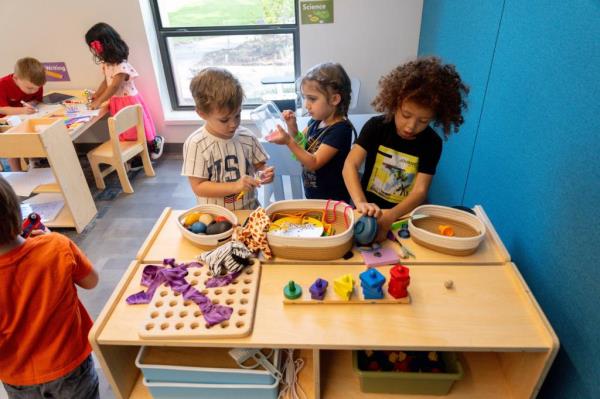Pre-K students playing with toys on their first day of school at Nature Explorers Preschool, Oklahoma City Zoo
