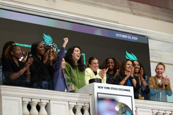 Members of the 2024 WNBA champion New York Liberty ring the opening bell on Wednesday.