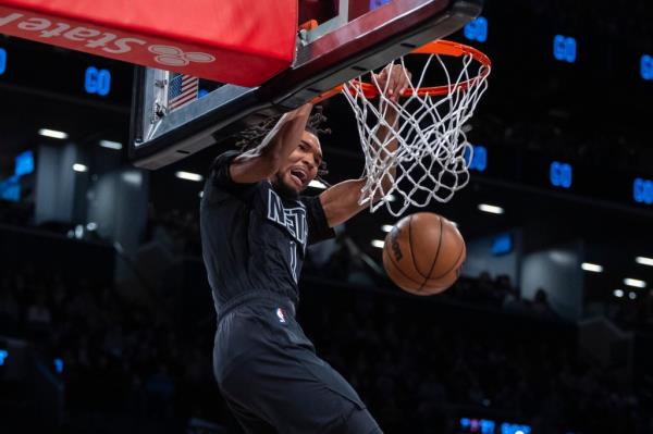 Ziaire Williams, who scored 18 points off the bench, slams one home during the Nets' overtime loss.