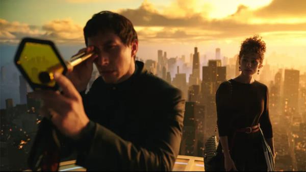 Adam Driver looking through a telescope.