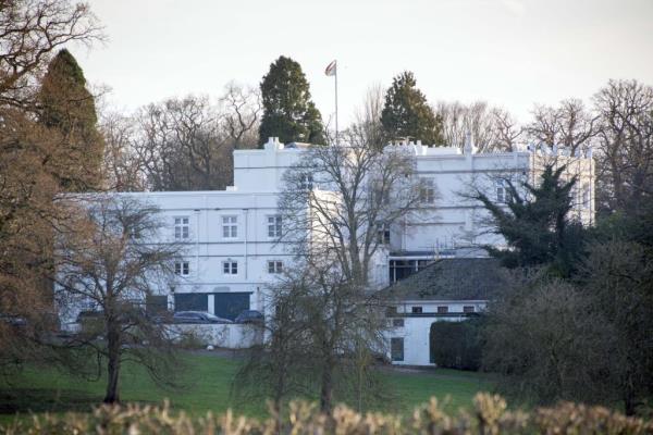 Prince Andrew's residence, the white building of Royal Lodge in Great Windsor Park, surrounded by trees and grass