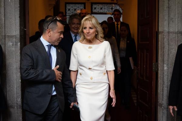Jill Biden and Anthony Bernal walking in a hallway before a speech in Quito, Ecuador.