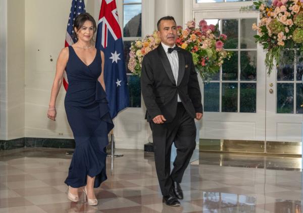 A man and a woman walking in front of flags at the Booksellers area of the White House, Washington D.C., for State Dinner ho<em></em>noring Prime Minister Anthony Albanese of Australia and Jodie Haydon