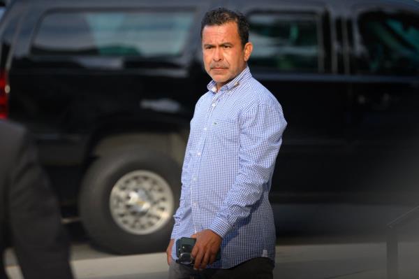 A man standing outside St. Edmond Roman Catholic Church, Delaware, waiting for President Biden to leave after attending Mass.