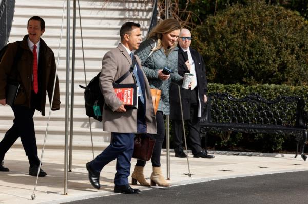 President Biden and first lady Jill Biden with staff walking to Marine One on the South Lawn of the White House.